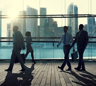 Business professionals walking on a rooftop terrace with cityscape